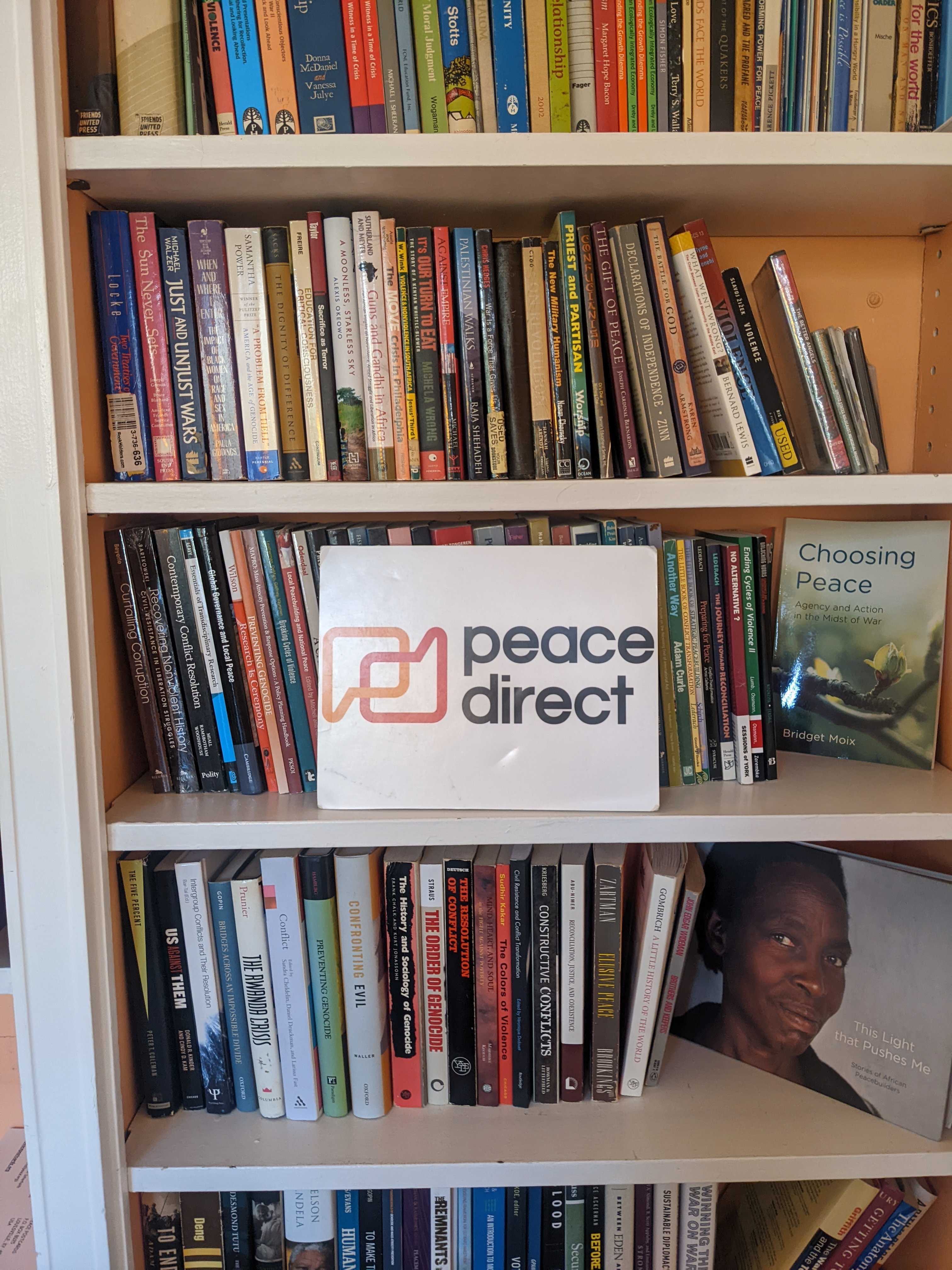Peace Direct sign on a bookshelf